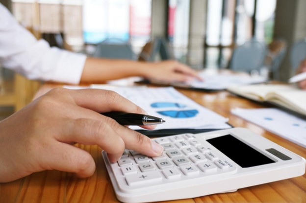 A cropped photo of a woman calculating expenses of their non-profit organization