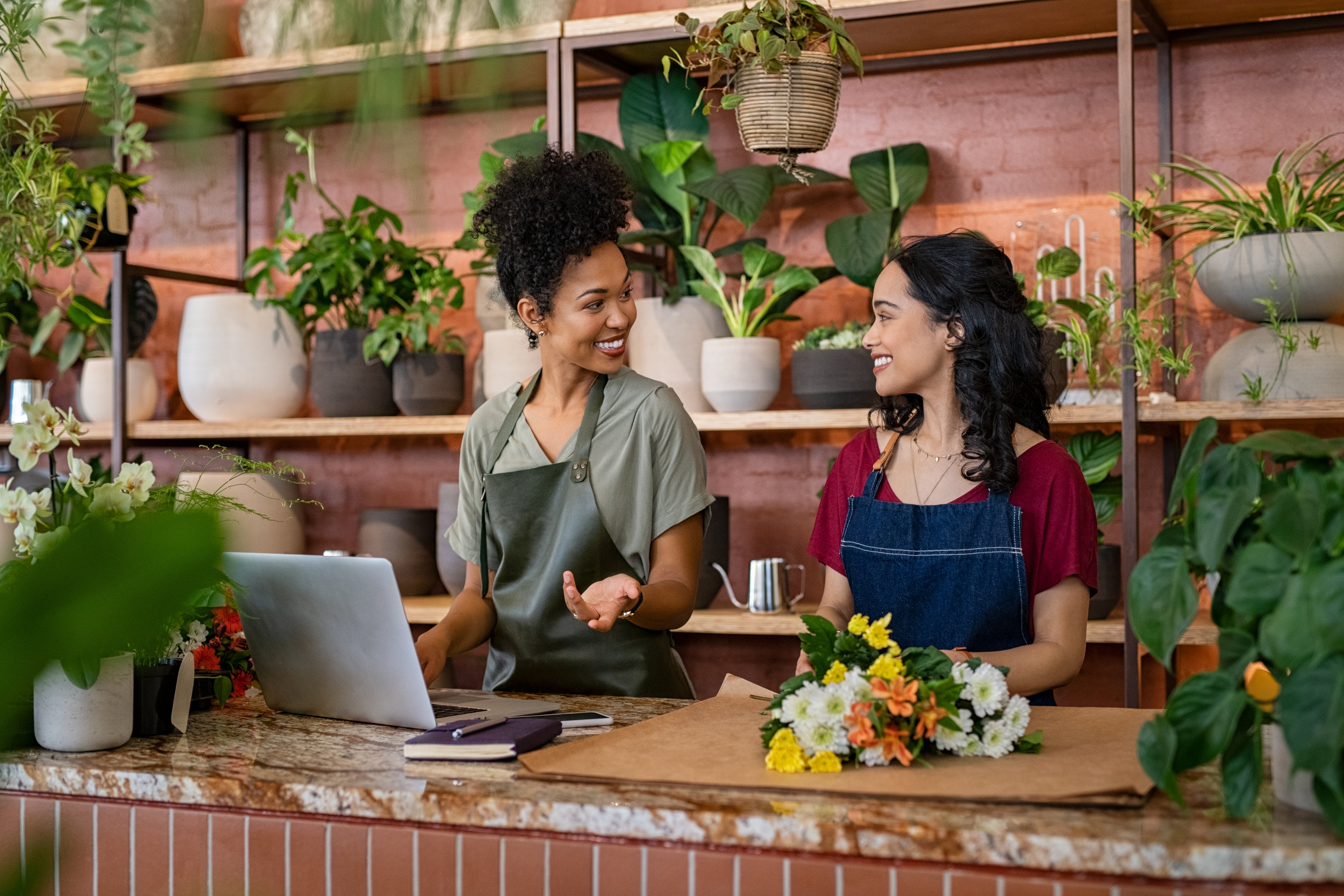 two-smiling-women-working-at-florist-shop-2022-02-15-23-33-52-utc two-smiling-women-working-at-florist-shop-2022-02-15-23-33-52-utc